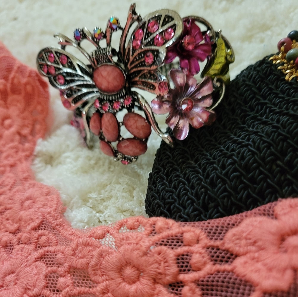 Rare Bangles featuring a butterfly motif, presented in a rustic pink & silver
